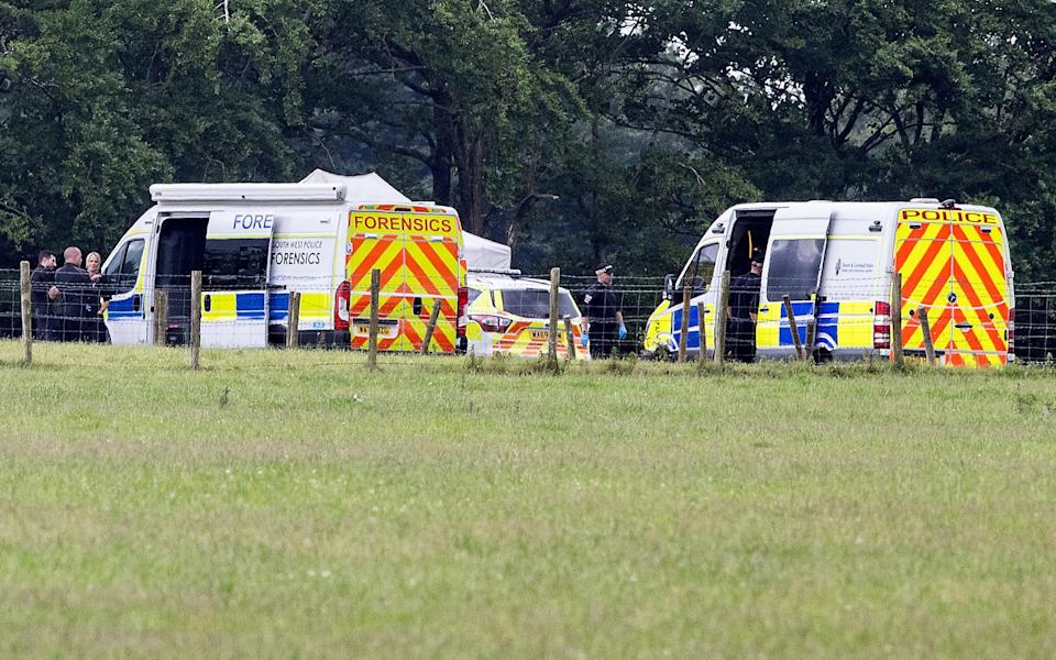 Police and forensics teams at the Devon airfield where two skydivers died