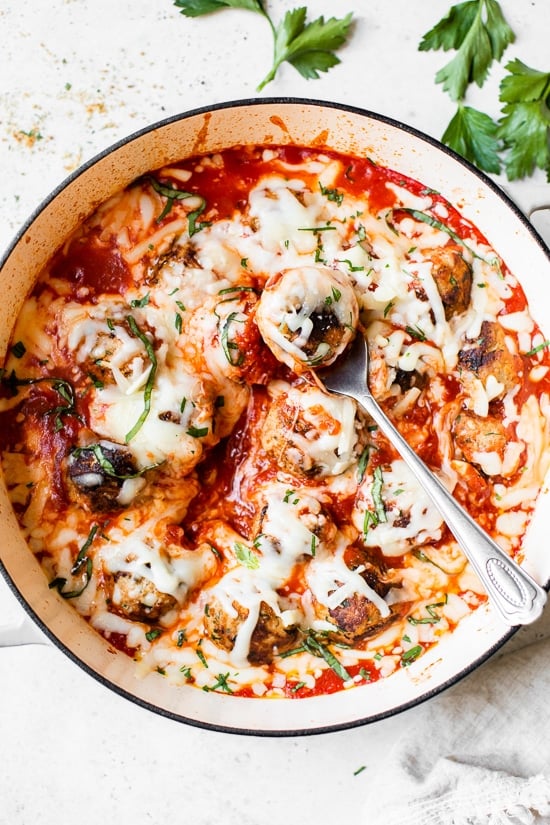 Cheesy Turkey Meatballs covered in sauce and cheese, made all in one skillet, serve this with a green salad and a little bread on the side for dipping!