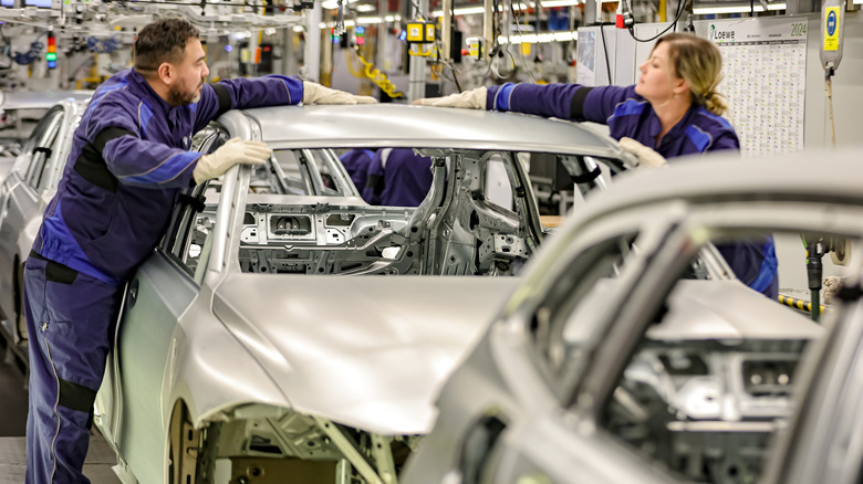 BMW workers assemble a vehicle at a factory in Germany