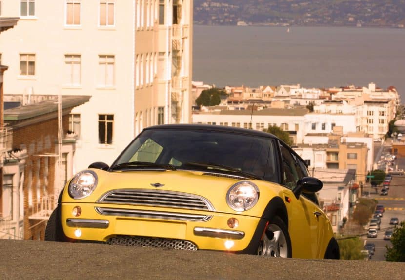 First-generation R50 MINI Cooper driving through San Francisco streets during the early 2000s relaunch